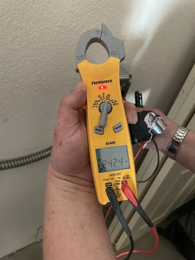 Voltage testing with clamp meter during Recessed Lighting Installation in Graham